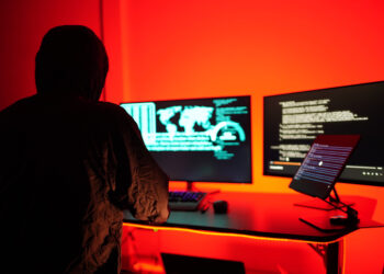 Hackers work secretly in secret rooms. Mysterious colored lights Breaking into personal security and various agencies in the world . Wanted Hacker using computer for hacking in the cyber data center .