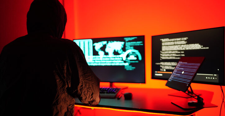 Hackers work secretly in secret rooms. Mysterious colored lights Breaking into personal security and various agencies in the world . Wanted Hacker using computer for hacking in the cyber data center .